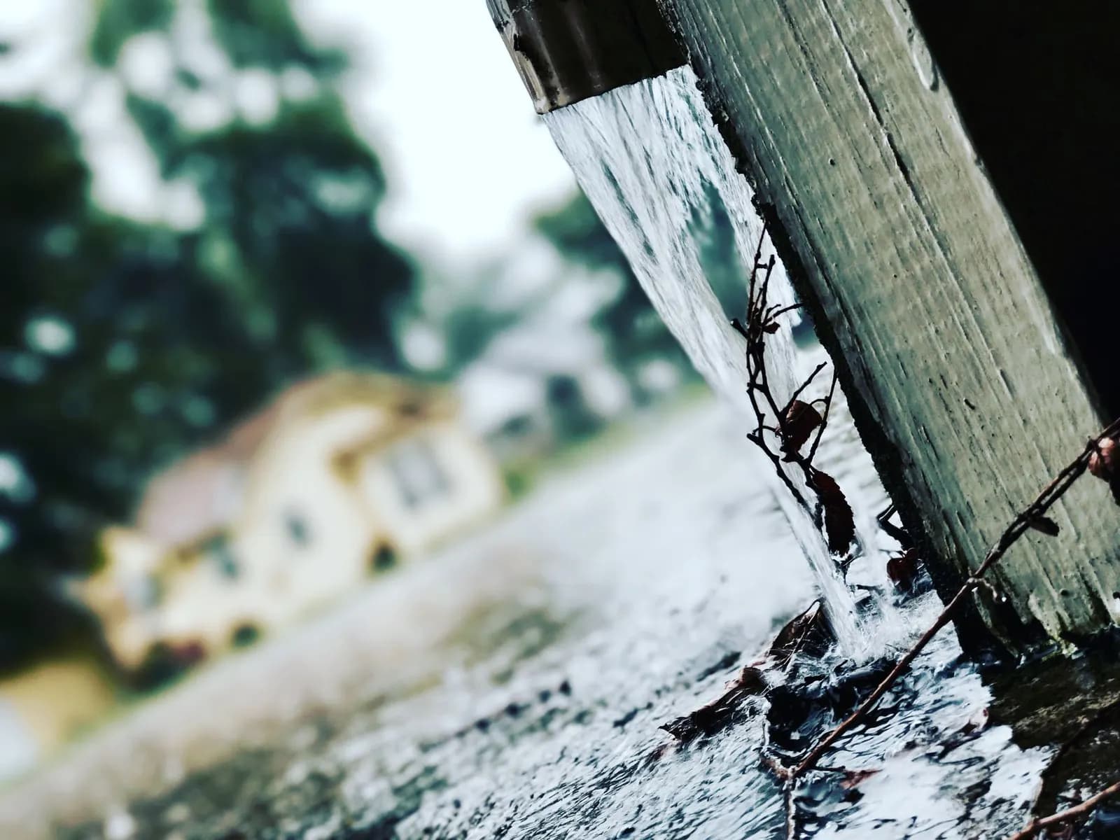 Rainwater overflowing from a blocked gutter